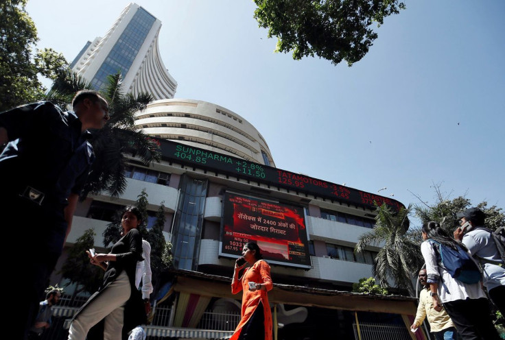 People walk past the Bombay Stock Exchange (BSE) building in Mumbai, India, March 9, 2020.