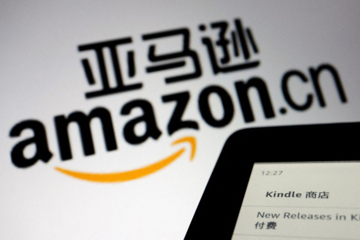 The sign of e-commerce website Amazon China is seen next to a Kindle e-reader displayed in this illustration , taken on December 15, 2021.