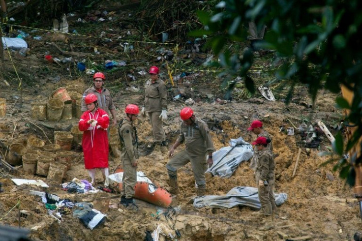 Firefighters recover the bodies of three victims of a landslide in the community Vila dos Milagres, Brazil on May 31