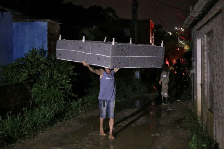 A man salvages a mattress after the landslide in the community Vila dos Milagres in Recife, Brazil