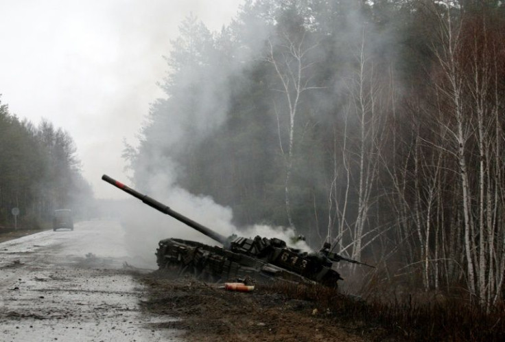 Smoke rises from a Russian tank destroyed by Ukrainian forces, on the side of a road in the eastern Lugansk region, where Russian forces control most of the city of Severodonetsk