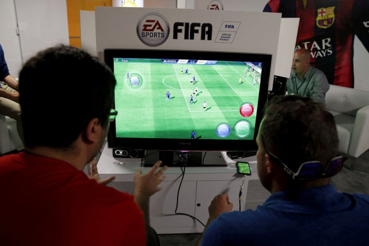 People play Electronic Arts' "FIFA" video game at the Microsoft Xbox booth at the Electronic Entertainment Expo, or E3, in Los Angeles, California, United States, June 16, 2015. 