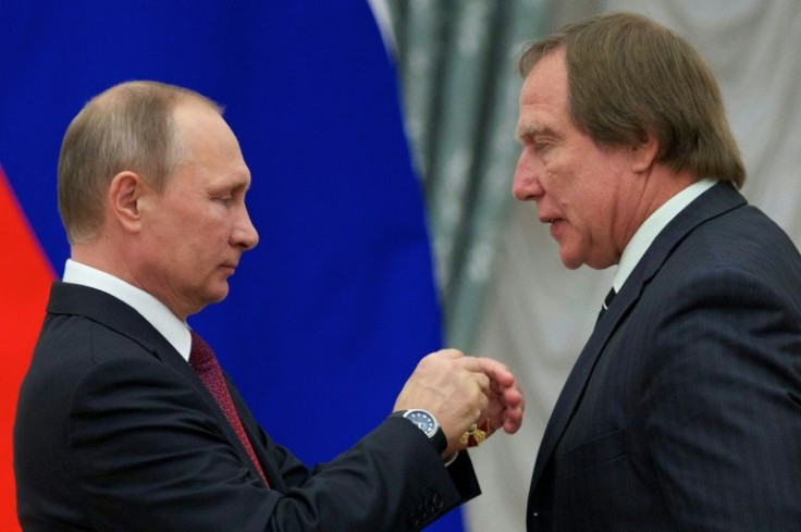 Russian President Vladimir Putin (L) and  cellist Sergei Roldugin, whom the US has hit with sanctions, calling him the Russian leader's money-manager.