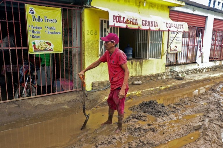 A man clears a street in Huatulco in southern Mexico after Hurricane Agatha triggered heavy rains and mudslides