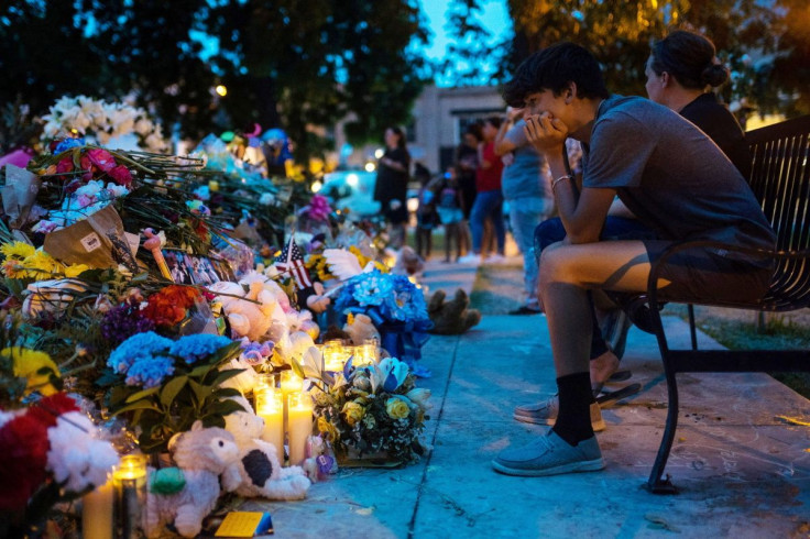 Mourners pay their respects at a memorial for the 21 killed in the mass shooting at Robb Elementary School, in the Uvalde Town Square in Uvalde, Texas on June 1, 2022.   Lucas Boland/USA TODAY NETWORK via REUTERS 