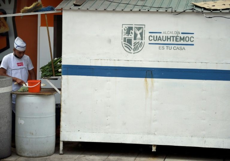 The colorful street food pictures in this district of Mexico City have been replaced by a government sign declaring that Cuauhtemoc "is your home"