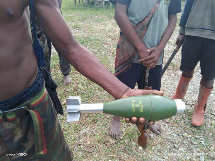 A local resident holds an unexploded mortar following the October aerial attacks in Kiwirok, Pegunungan Bintang regency, Papua, Indonesia, October 18, 2021. Courtesy of West Papua National Liberation Army (TPNPB)/Handout via REUTERS