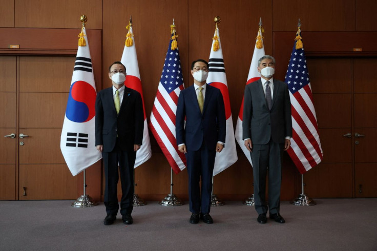 Kim Gunn, South Korea's new special representative for Korean Peninsula peace and security affairs, his U.S. counterpart Sung Kim and Japanese counterpart Takehiro Funakoshi pose for photographs before their meeting at the Foreign Ministry in Seoul, South