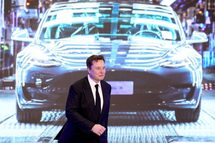 Tesla Inc CEO Elon Musk walks next to a screen showing an image of Tesla Model 3 car during an opening ceremony for Tesla China-made Model Y program in Shanghai, China January 7, 2020. 