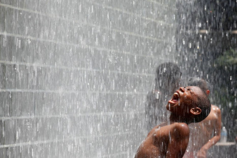 A boy cools off at the Crown Fountain at Millennium Park in Chicago, July 21, 2011. 
