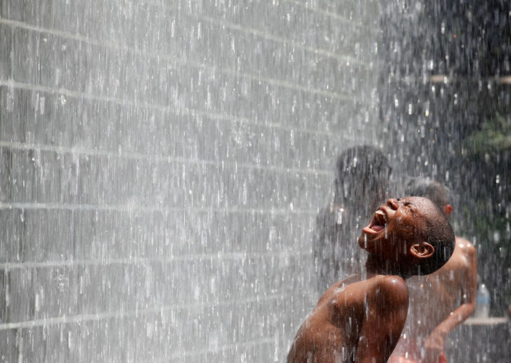 A boy cools off at the Crown Fountain at Millennium Park in Chicago, July 21, 2011. 