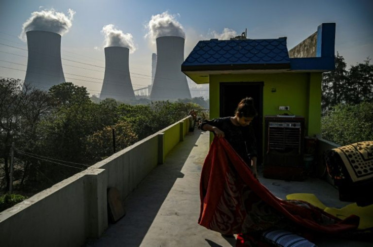 A girl stands near a power plant in Dadri in India -- the main US climate agency says CO2 levels in the atmosphere are at their highest level for four million years