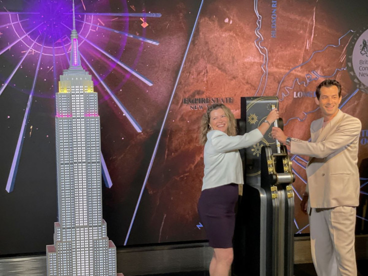 Emma Wade-Smith, British Consul General to New York and Mark Ronson, British-American DJ, songwriter and producer gesture, at the Empire State Building in New York City, U.S. June 3, 2022.