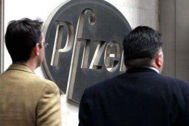 People walk past the Pfizer  World headquaters in New York, February 3, 2010