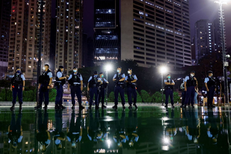 Police officers stand guard after announcing a closure of a part of Victoria Park, where the candlelight vigil used to be held, a day a head of the 33rd anniversary of the crackdown on pro-democracy demonstrations at Beijing's Tiananmen Square, in Hong Ko