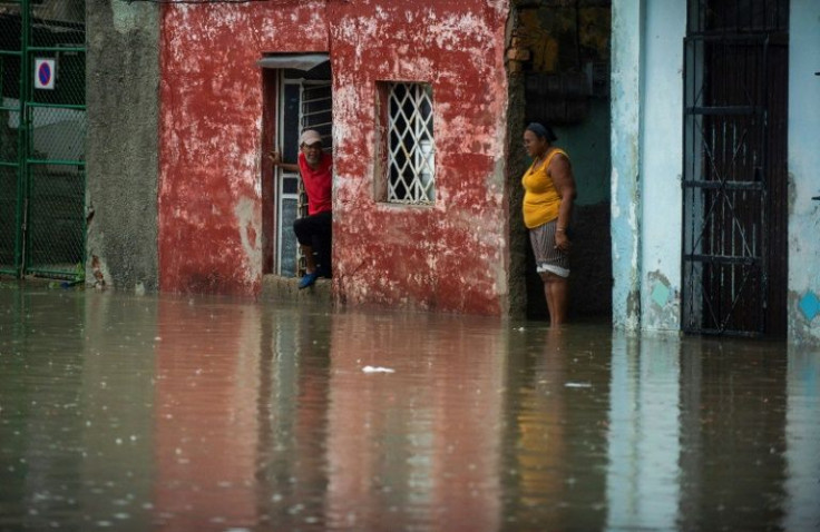 People look at a flooded street from a house of Havana, on June 3, 2022