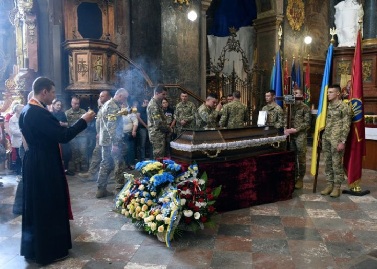 A priest serves at the funeral of a Ukrainian serviceman killed in battle