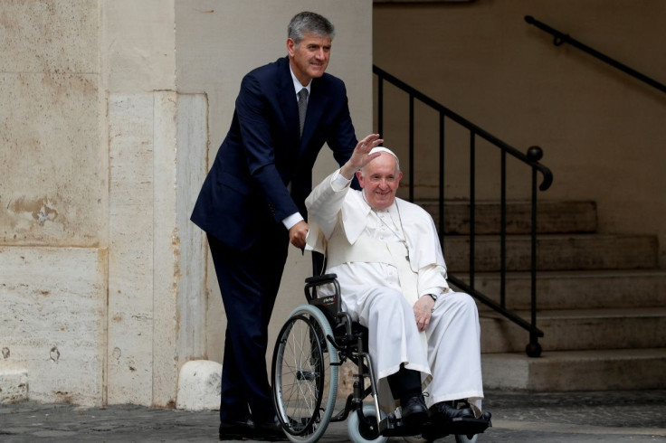 Pope Francis waves as he leaves in a wheelchair after meeting children with disabilities and Ukrainian children who fled their country due to Russia's invasion, at the Vatican, June 4, 2022. 