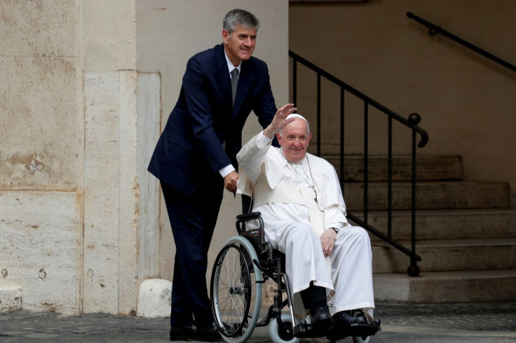 Pope Francis waves as he leaves in a wheelchair after meeting children with disabilities and Ukrainian children who fled their country due to Russia's invasion, at the Vatican, June 4, 2022.