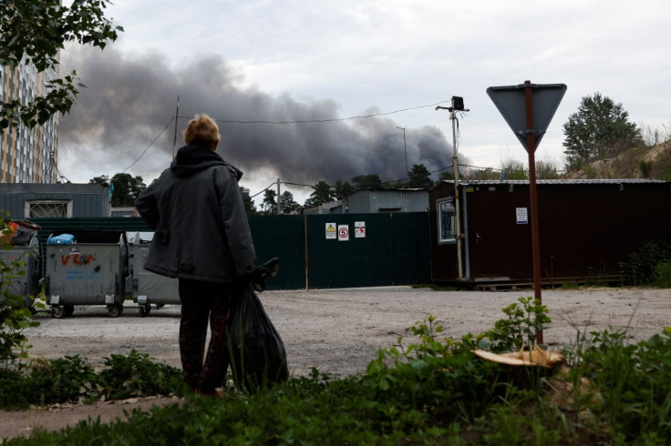 A man looks at the smoke after explosions were heard as Russia's attacks on Ukraine continues, in Kyiv, Ukraine June 5, 2022.