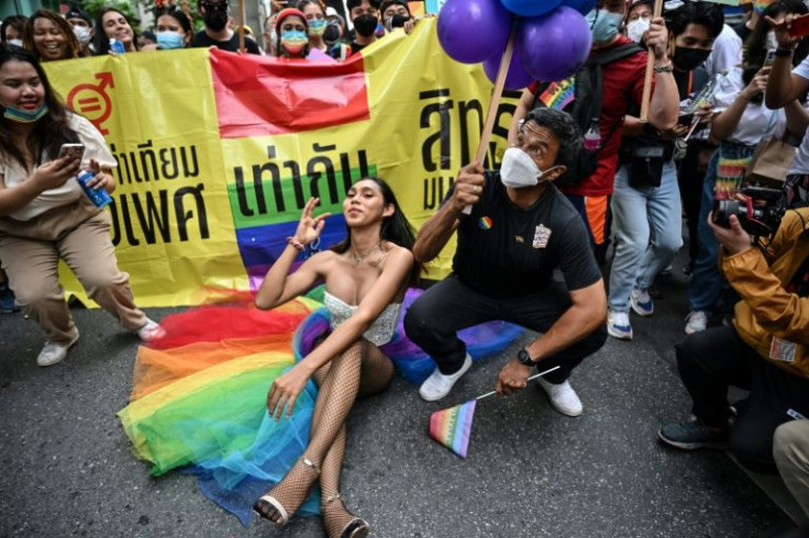 Bangkok Governor Chadchart Sittiput (R) interacts with members of the LGBTQIA+ community as they take part in the Pride March in Bangkok on June 5, 2022