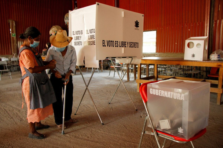 A woman folds a ballot during the state elections, in Santa Maria Atzompa, in Oaxaca state, Mexico June 5, 2022.