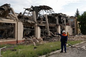 A employee stands next to a facility of the Darnytsia Car Repair Plant damaged by missile strikes, as Russia's attacks Ukraine in continues, in Kyiv, Ukraine June 5, 2022.  