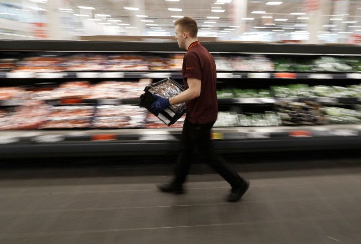 A Sainsbury's worker stacks a vegetable shelf in a store in Redhill, Britain, March 27, 2018. 