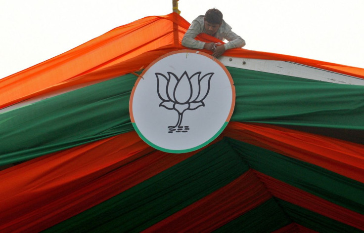 A man installs the symbol of India's ruling Bharatiya Janata Party (BJP) on a tent during an election campaign rally by the party in Prayagraj, India, February 24, 2022.