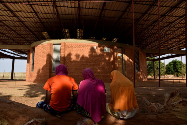 Girls study for their final exam as they sit in front of the library that was built by Francis Kere, an architect who won Pritzker Prize in his native village Gando, Burkina Faso June 4, 2022.