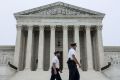 Police officers walk outside the U.S. Supreme Court in Washington, U.S., May 3, 2022. 