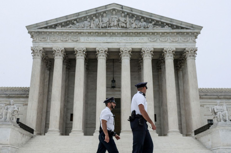 Police officers walk outside the U.S. Supreme Court in Washington, U.S., May 3, 2022. 