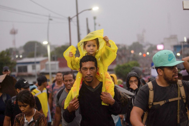A child sits on a man's shoulders, as migrants take part in a caravan to cross the country to reach the U.S. border, while regional leaders gather in Los Angeles to discuss migration and other issues, in Tapachula, Mexico June 6, 2022. 