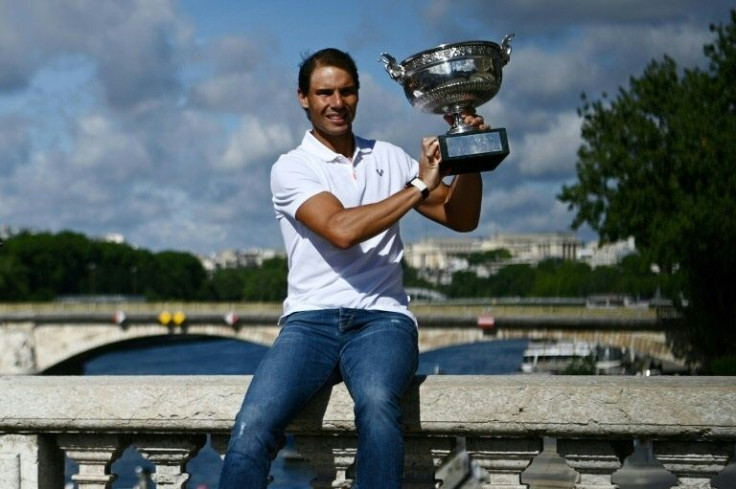 He'll always have Paris: Rafael Nadal showing off his French Open trophy on Pont Alexandre III in Paris the day after his victory