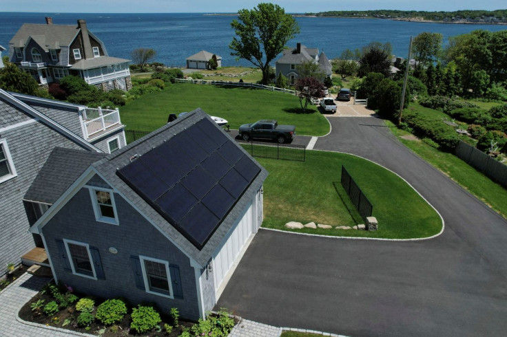 Solar panels create electricity on the roof of a house in Rockport, Massachusetts, U.S., June 6, 2022. Picture taken with a drone.    