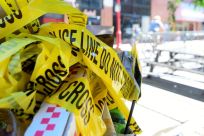 Police tape is pictured at a trash can on the street, at a crime scene after a deadly mass shooting on South Street in Philadelphia, Pennsylvania, U.S., June 5, 2022.  