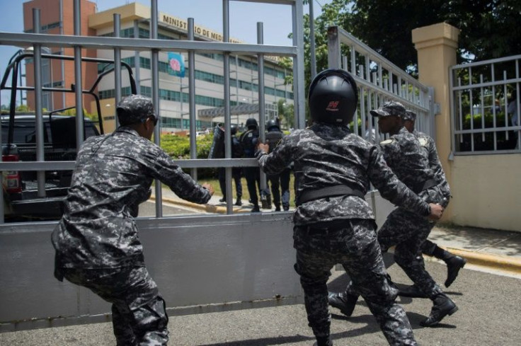 Police close the gate of the Dominican environment ministry headquarters after a shooting, in Santo Domingo, on June 6, 2022
