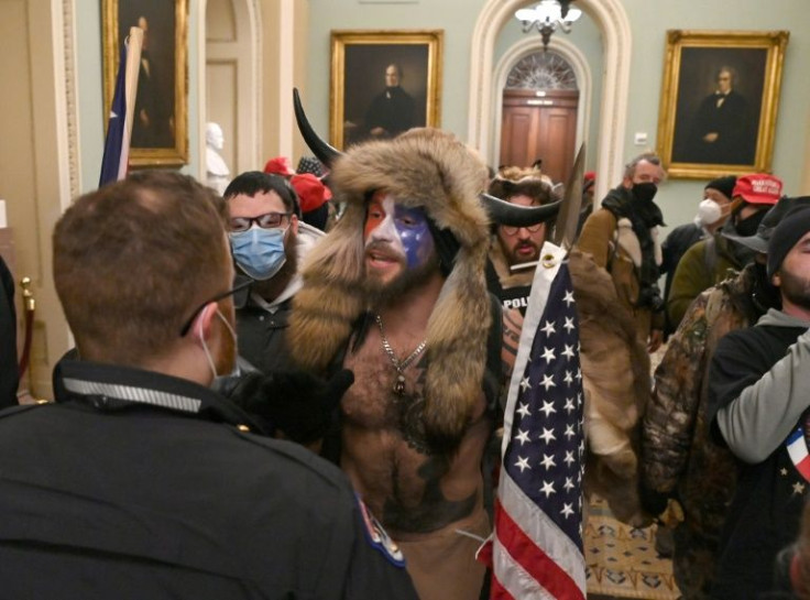 Supporters of Donald Trump, including the so-called "QAnon Shaman," enter the US Capitol on January 6, 2021