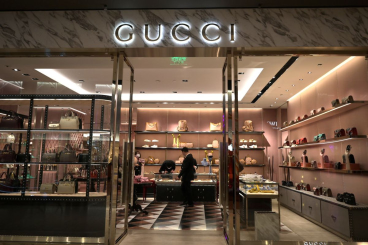 Staff members wearing face masks are seen inside a store of an Italian luxury brand Gucci at a shopping mall, as the country is hit by an outbreak of the novel coronavirus, in Beijing, China February 20, 2020. 
