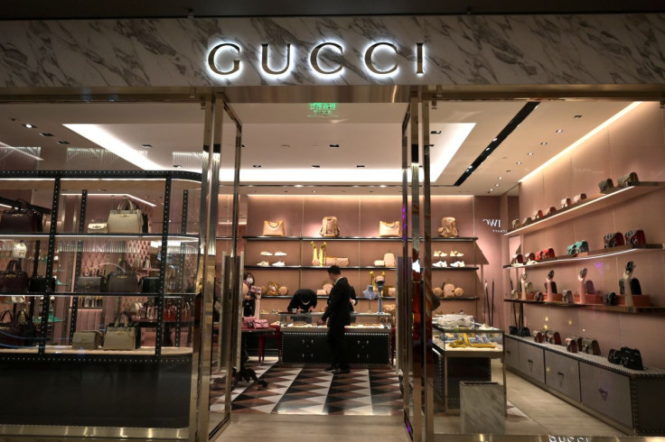 Staff members wearing face masks are seen inside a store of an Italian luxury brand Gucci at a shopping mall, as the country is hit by an outbreak of the novel coronavirus, in Beijing, China February 20, 2020.