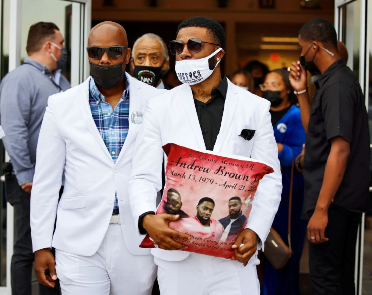 Jha'rod Ferebee, son of Andrew Brown Jr., carries one of the commemorative pillows that was given to each close relative at the funeral as he leaves the church in Elizabeth City, North Carolina, U.S. May 3, 2021.