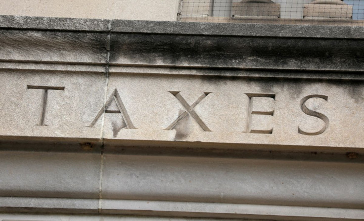 The word "taxes" is seen engraved at the headquarters of the Internal Revenue Service (IRS) in Washington, D.C., U.S., May 10, 2021. 