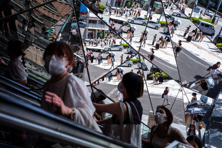 People wearing protective masks are reflected in the mirror at a shopping mall in Tokyo amid the coronavirus disease (COVID-19) outbreak in Tokyo, Japan, August 19, 2021. 