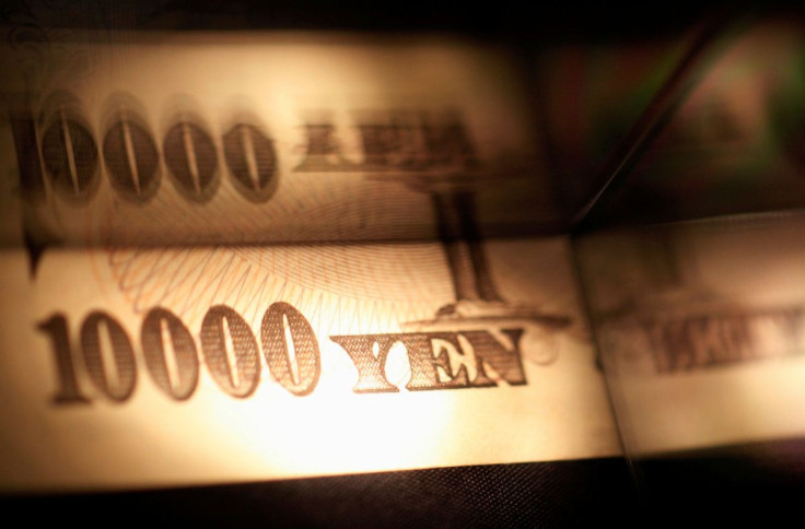 Light is cast on a Japanese 10,000 yen note as it's reflected in a plastic board in Tokyo, in this February 28, 2013 picture illustration.