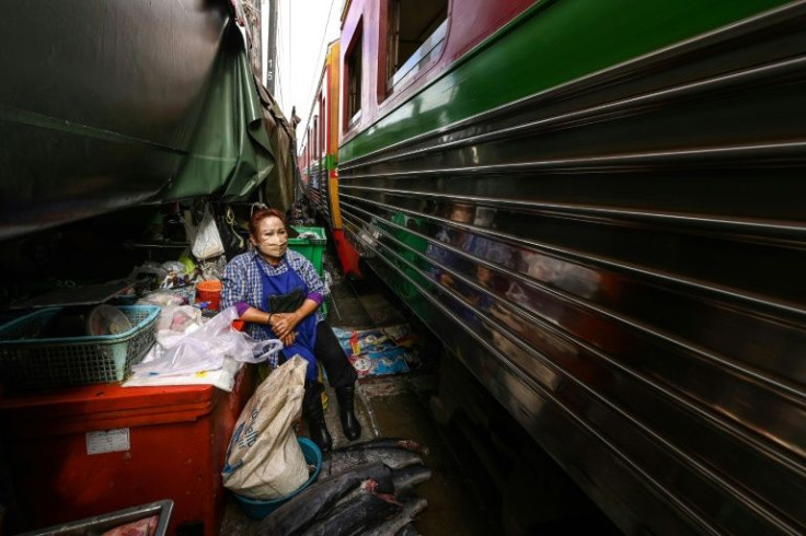 Mae Klong market vendors insist there is no danger despite operating in close quarters with the train