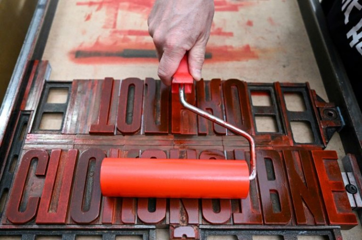 Sergei Besov uses an old printing press with wooden Cyrillic type and vintage red ink to create Soviet-style posters with modern messages