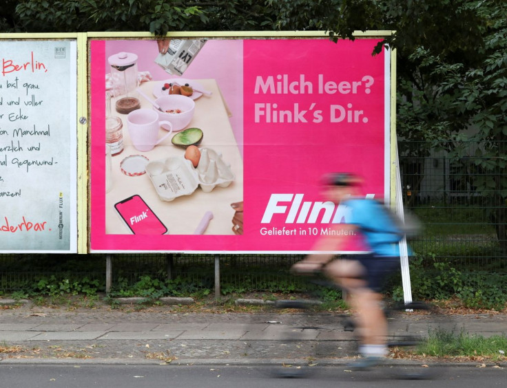 A cyclist drives past an advertisement promoting the grocery delivery company "Flink", in Berlin, Germany, August 13, 2021.