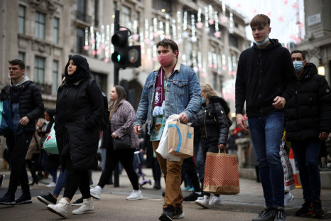 Shoppers walk through Oxford Circus, amid the coronavirus disease (COVID-19) outbreak in London, Britain, December 23, 2021. 