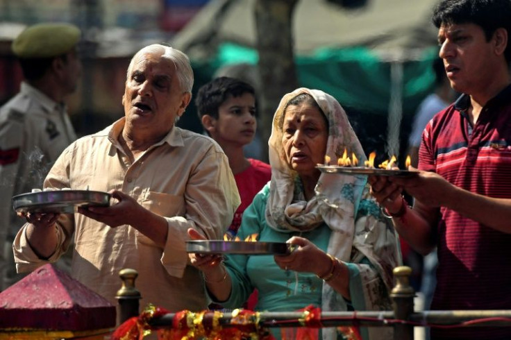 Hindu devotees perform religious rituals during a Hindu festival at a temple on the outskirts of Srinagar