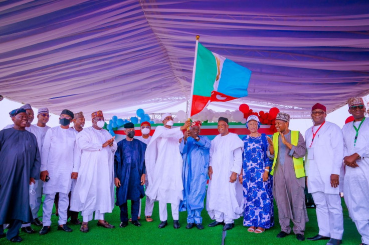 APC party's new presidential candidate Bola Tinubu raises a party's flag with Nigeria's President Muhammadu Buhari next to Abdullahi Adamu, the APC party chairman, during the party convention in Abuja, Nigeria June 7, 2022. Nigeria's Presidency/Handout vi
